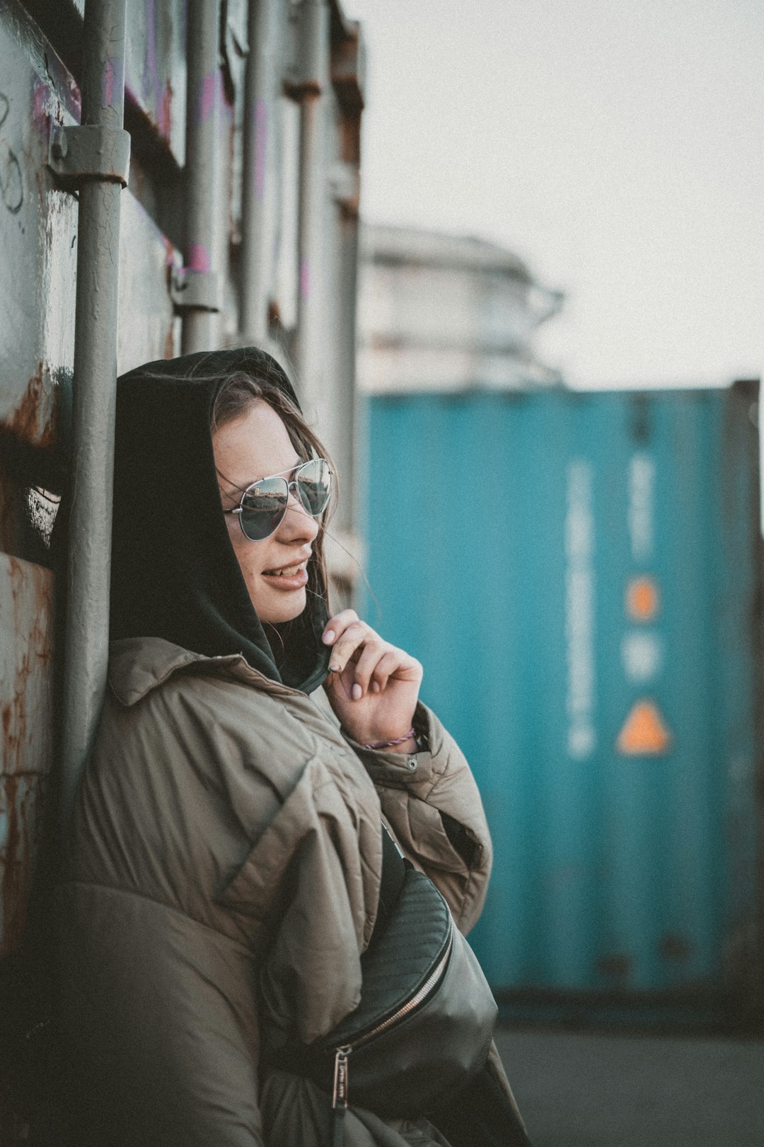 woman in brown coat wearing black sunglasses