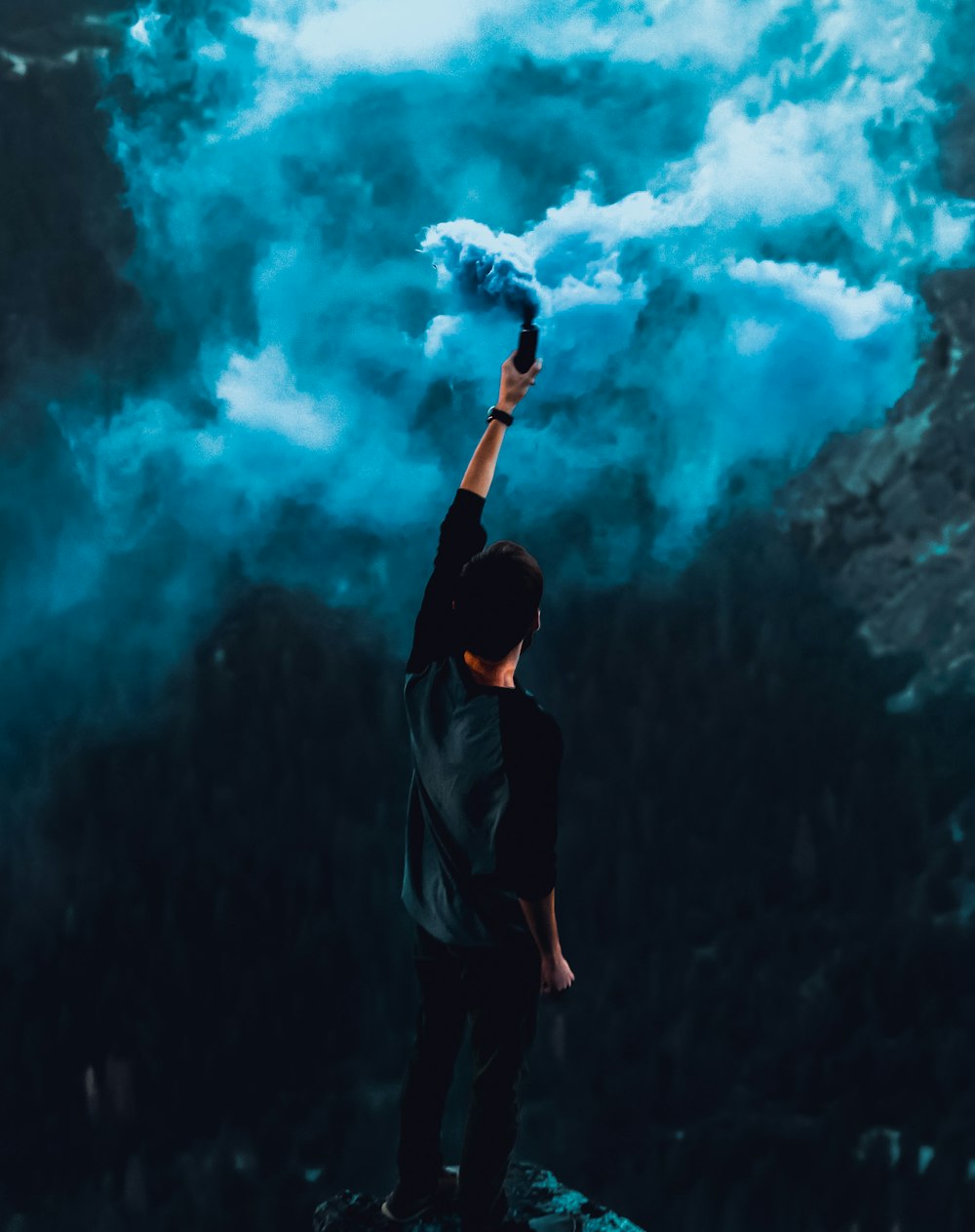 Frau im schwarzen Langarmshirt vor blauen und weißen Wolken