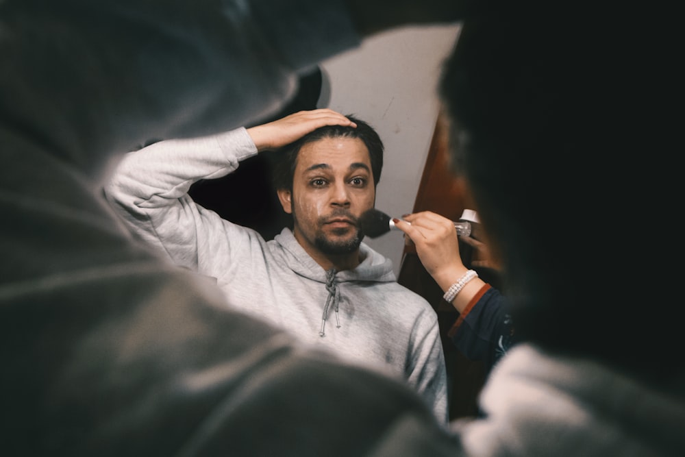 man in white dress shirt smoking cigarette