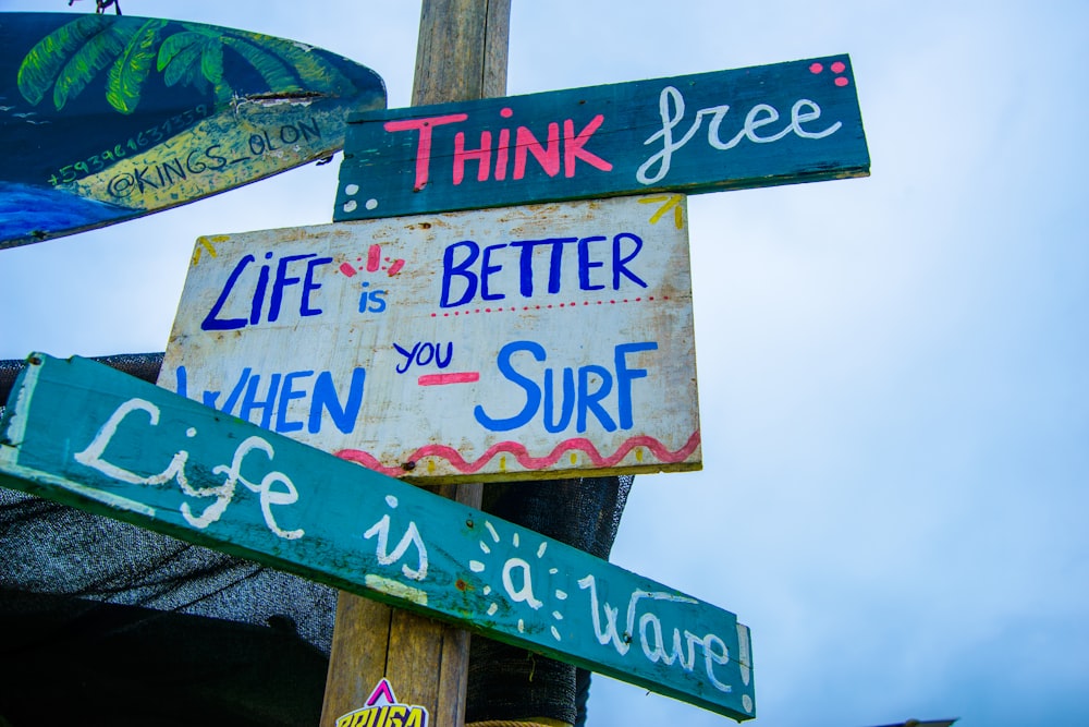 green and white wooden signage