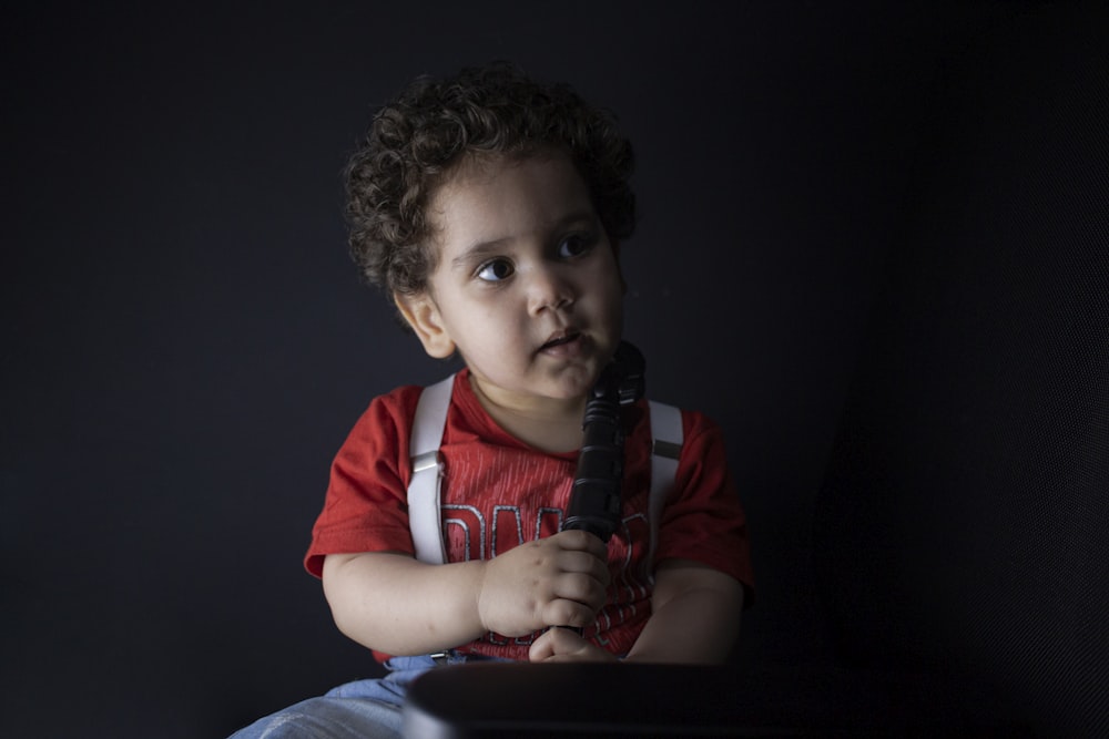 boy in red and white long sleeve shirt