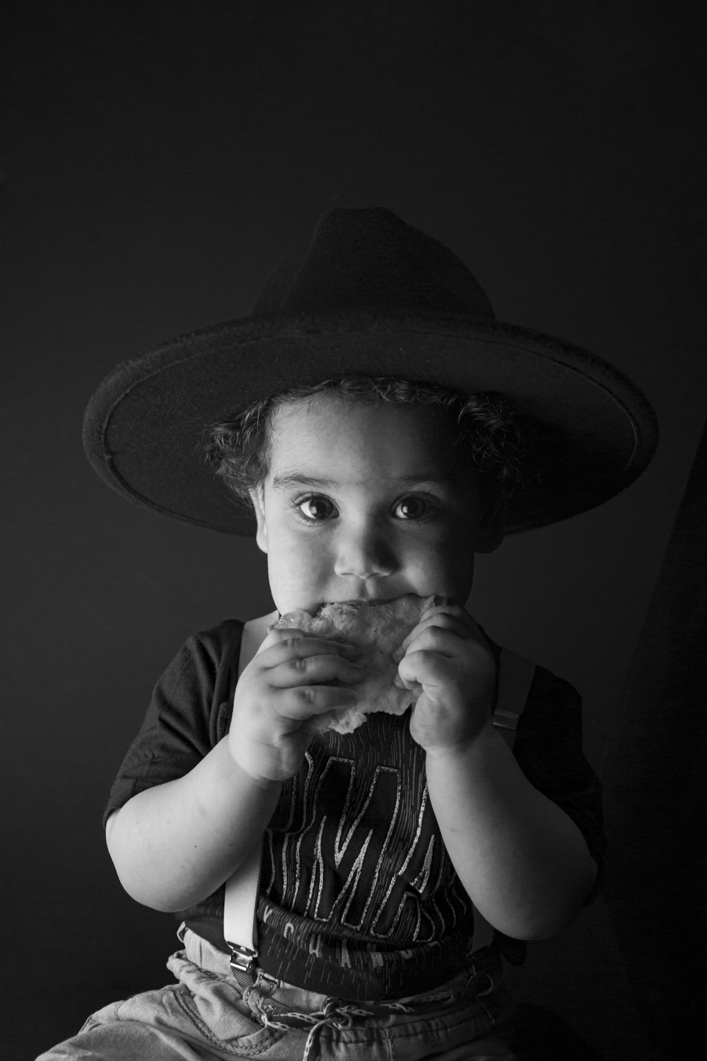grayscale photo of child wearing hat