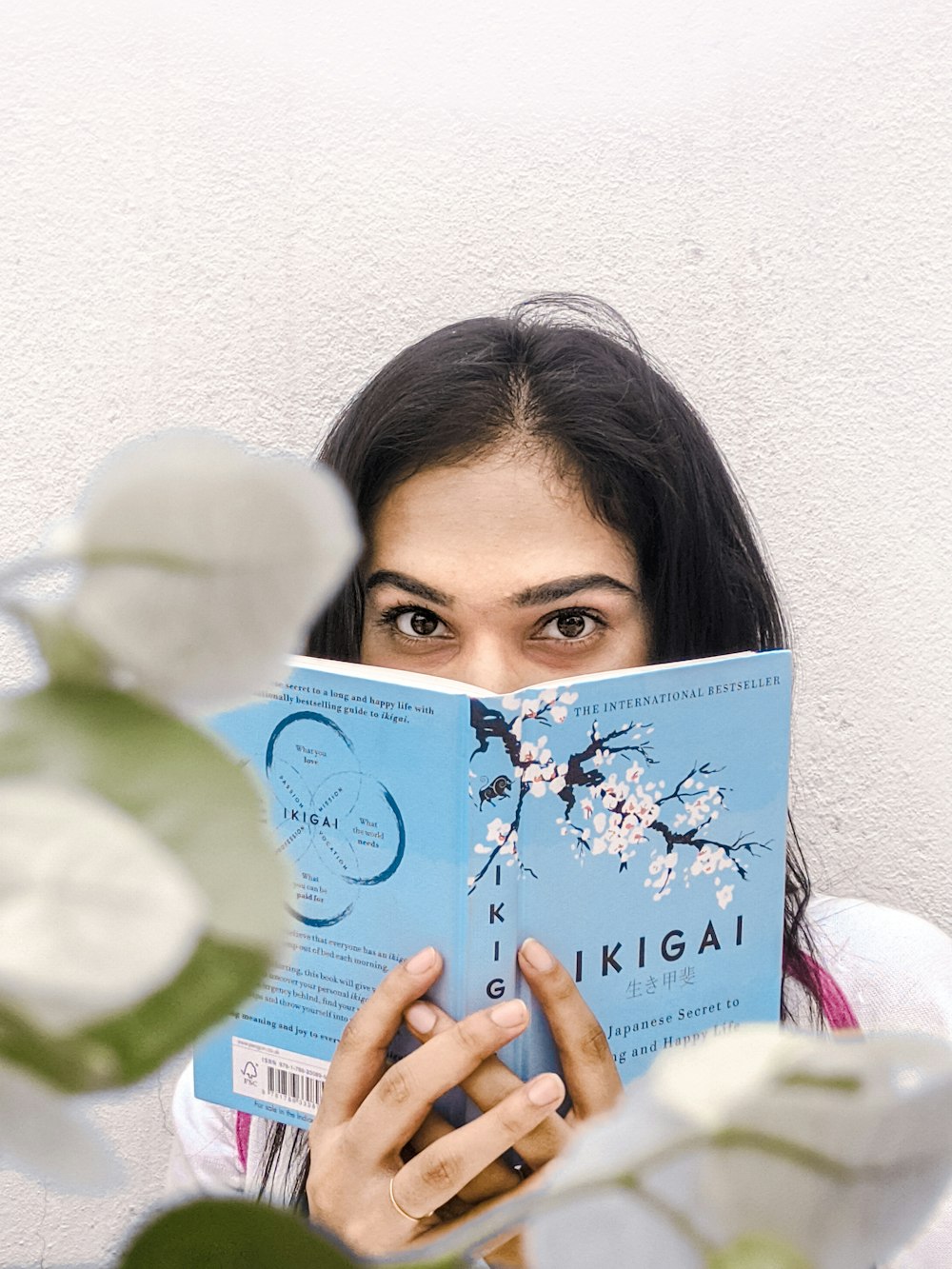 woman holding blue and white book