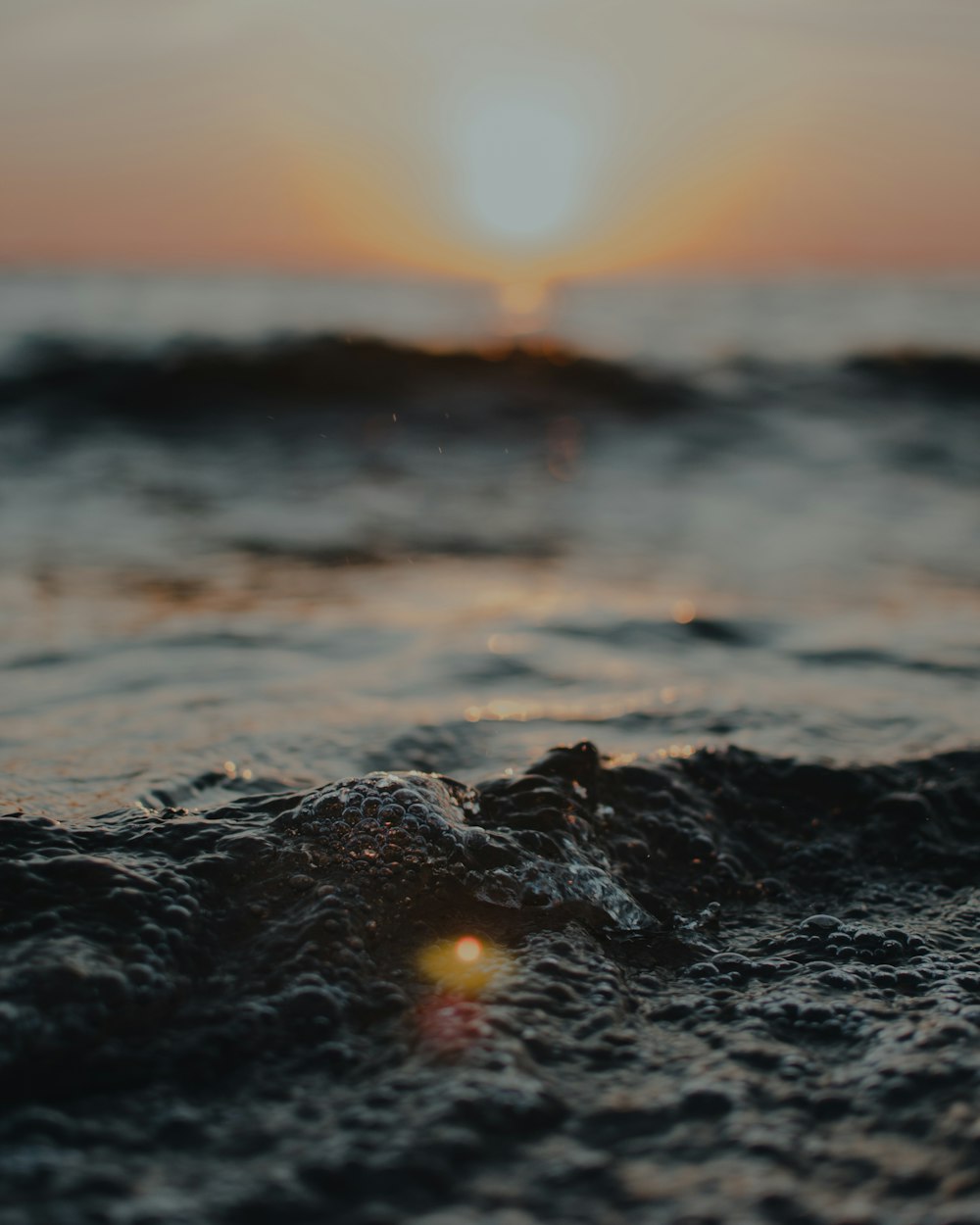 water waves on shore during sunset