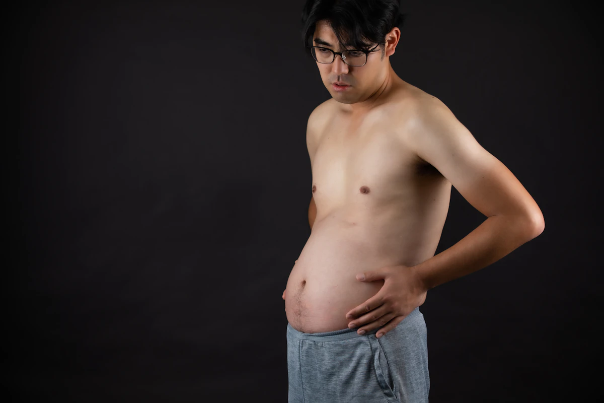 Close-up of a man's midsection, illustrating how abdominal obesity lowers testosterone in men.