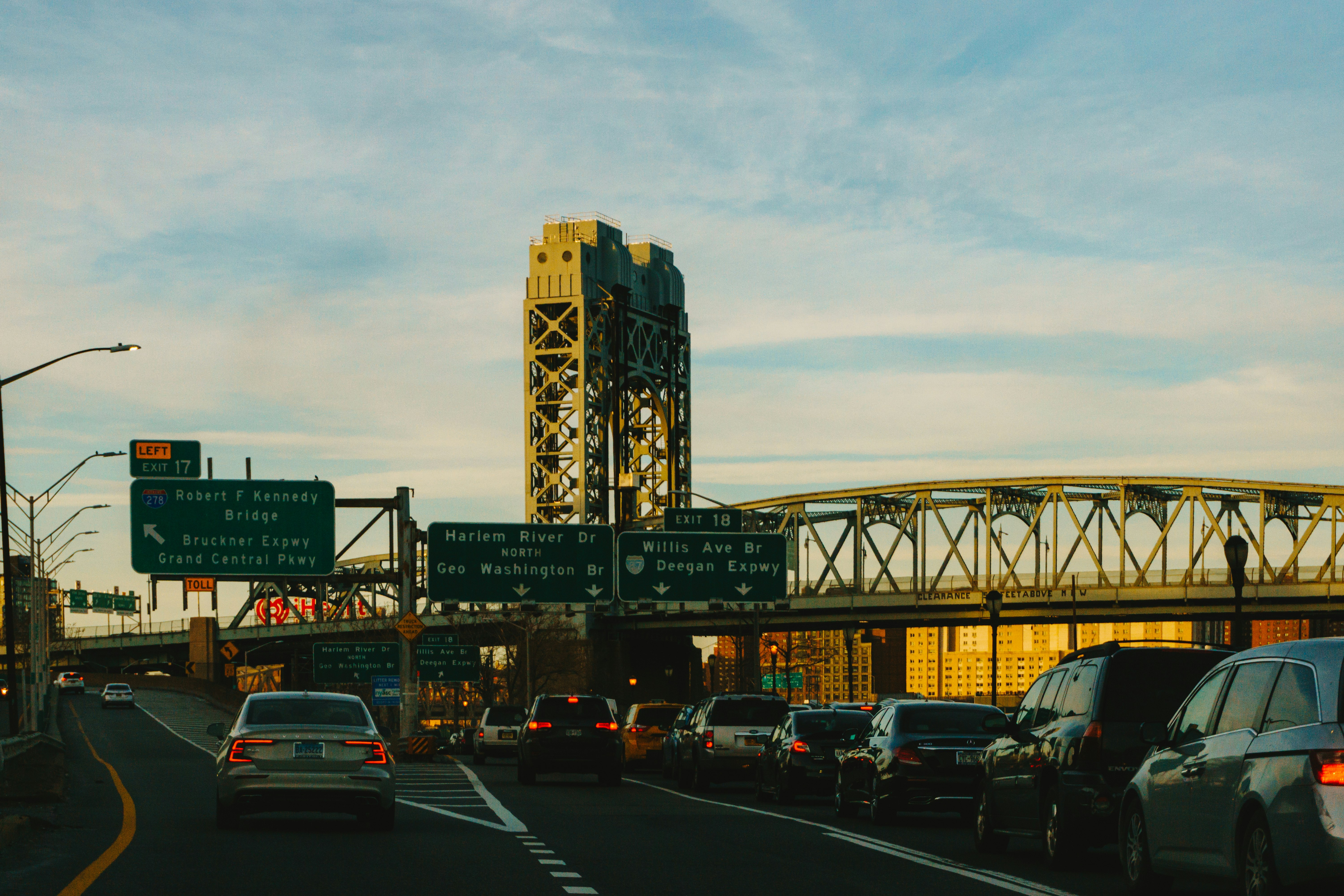 cars on road near bridge during daytime