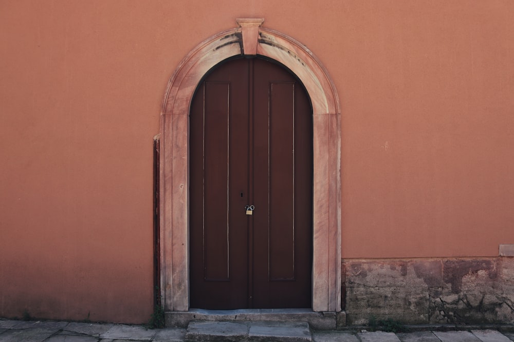 brown wooden door on brown concrete wall