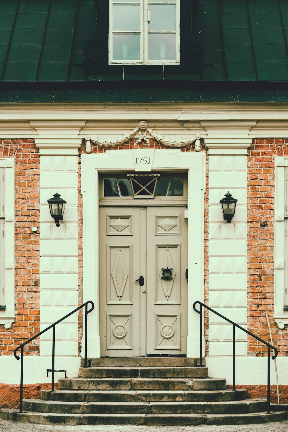 white wooden door on brown brick building