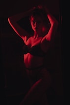 woman in black brassiere and white pants