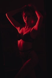 woman in black brassiere and white pants