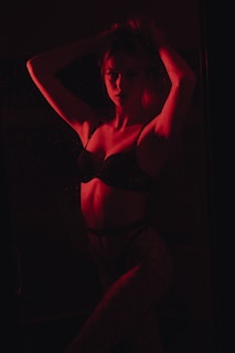 woman in black brassiere and white pants