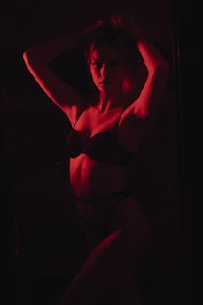 woman in black brassiere and white pants