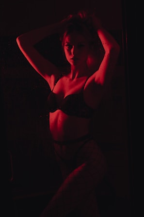 woman in black brassiere and white pants