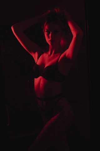 woman in black brassiere and white pants