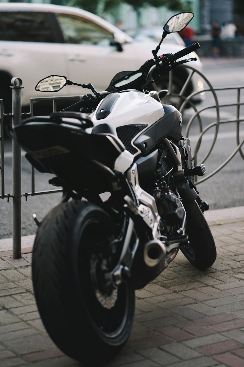 black and silver motorcycle on gray concrete floor