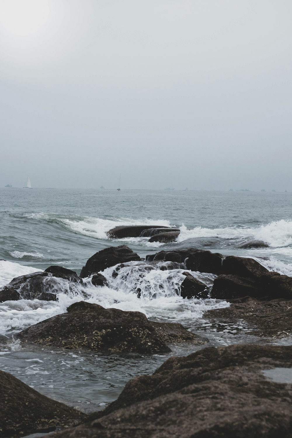 black rock formation on sea during daytime