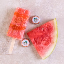watermelon slices beside blue and white cup