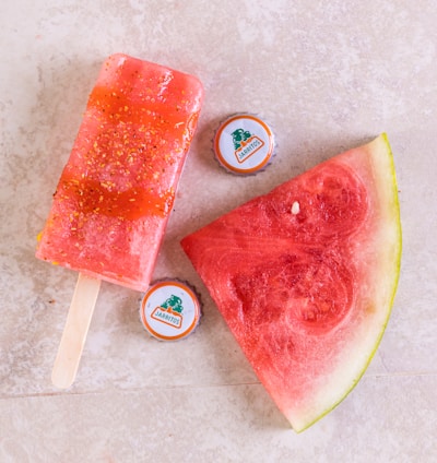 watermelon slices beside blue and white cup