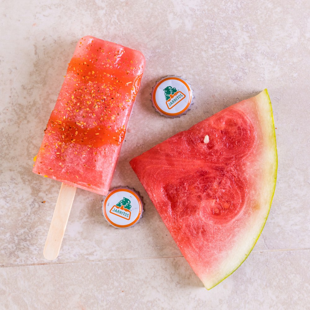 watermelon slices beside blue and white cup