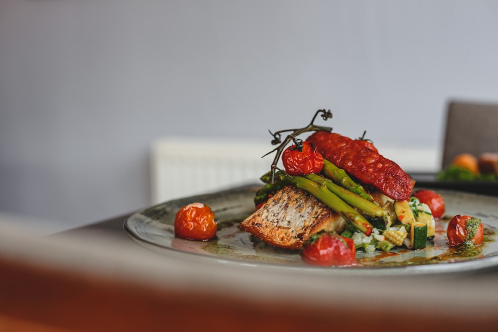 red tomato on white ceramic plate