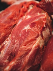 Close-up view of raw red meat with visible marbling and natural textures.