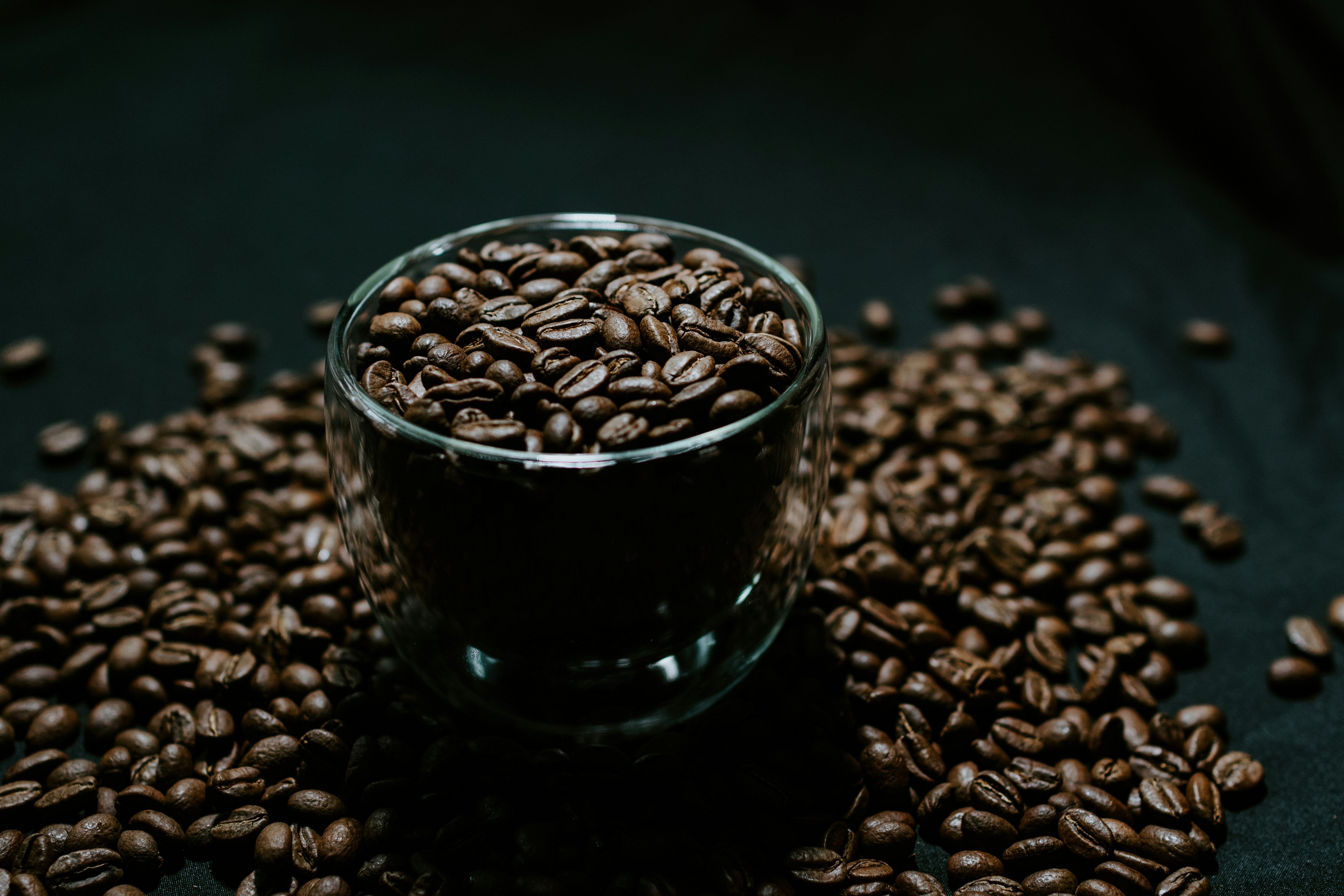 black ceramic mug on brown coffee beans