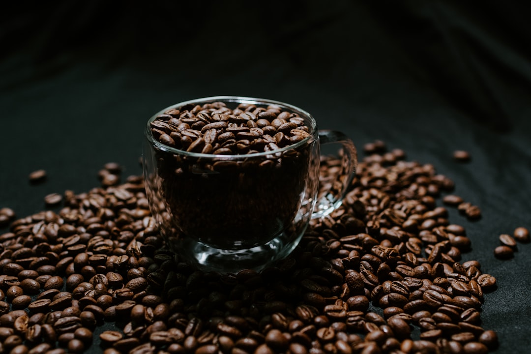 black ceramic mug on brown coffee beans