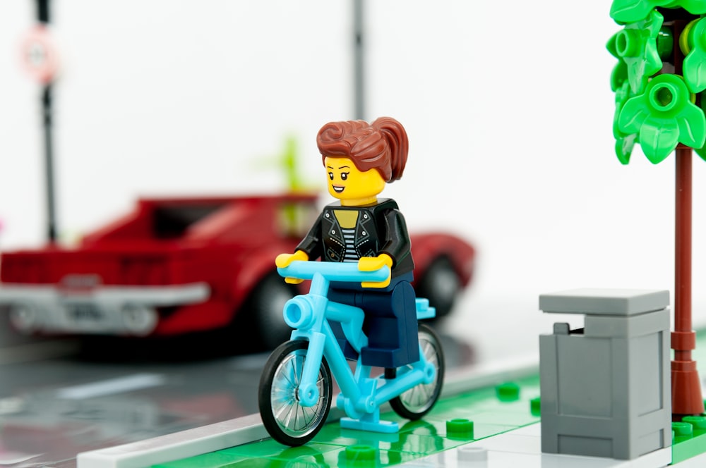 lego minifig riding on bicycle