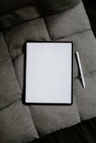 white tablet computer on gray textile