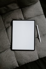 white tablet computer on gray textile