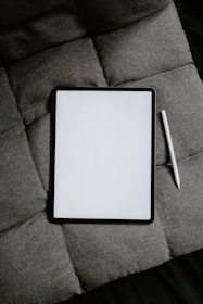 white tablet computer on gray textile