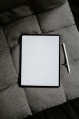 white tablet computer on gray textile