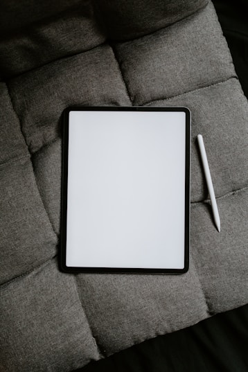 white tablet computer on gray textile