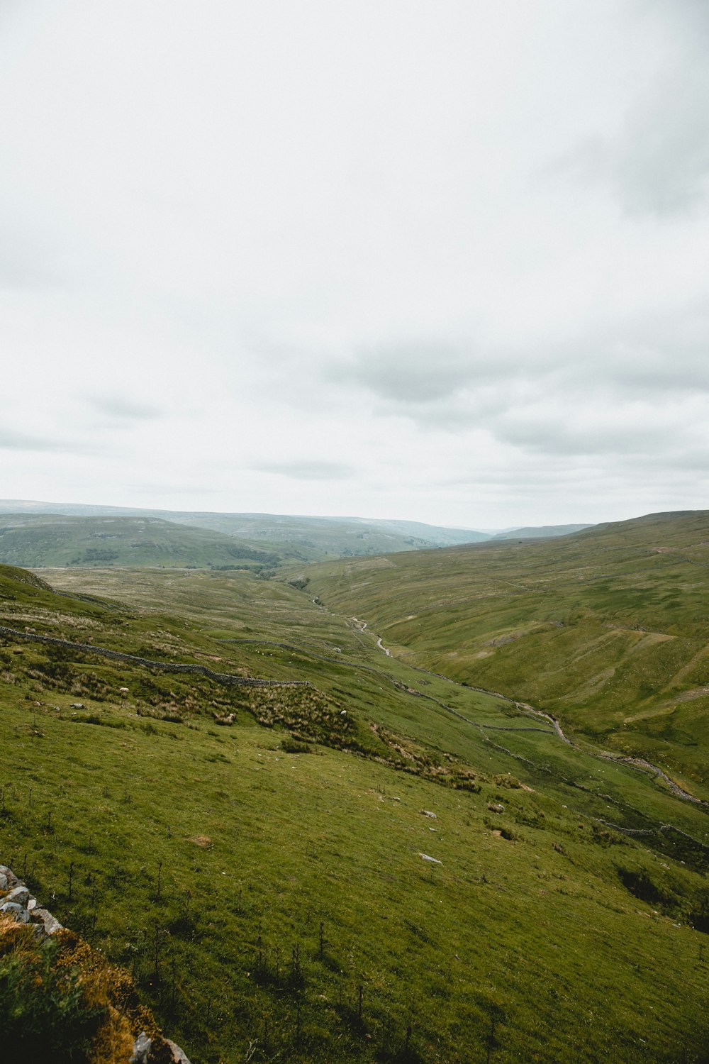 green and brown mountains under white clouds during daytime