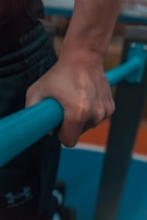 Close-up of hands gripping gym equipment during workout.