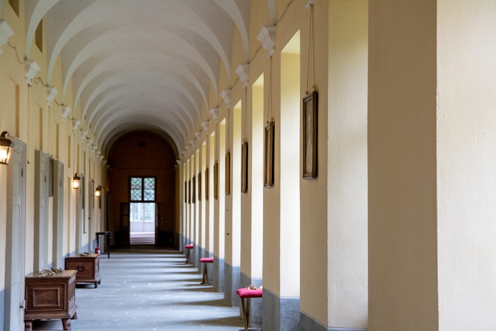 white and brown hallway with red carpet