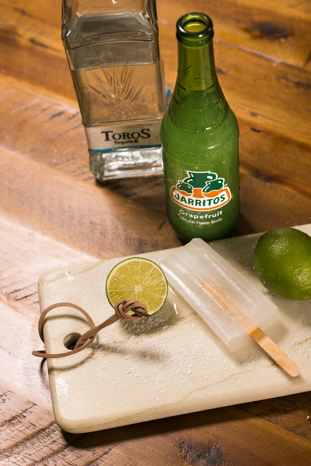 green plastic bottle beside silver key