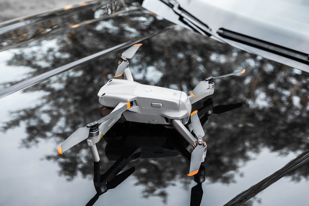 white and black drone flying