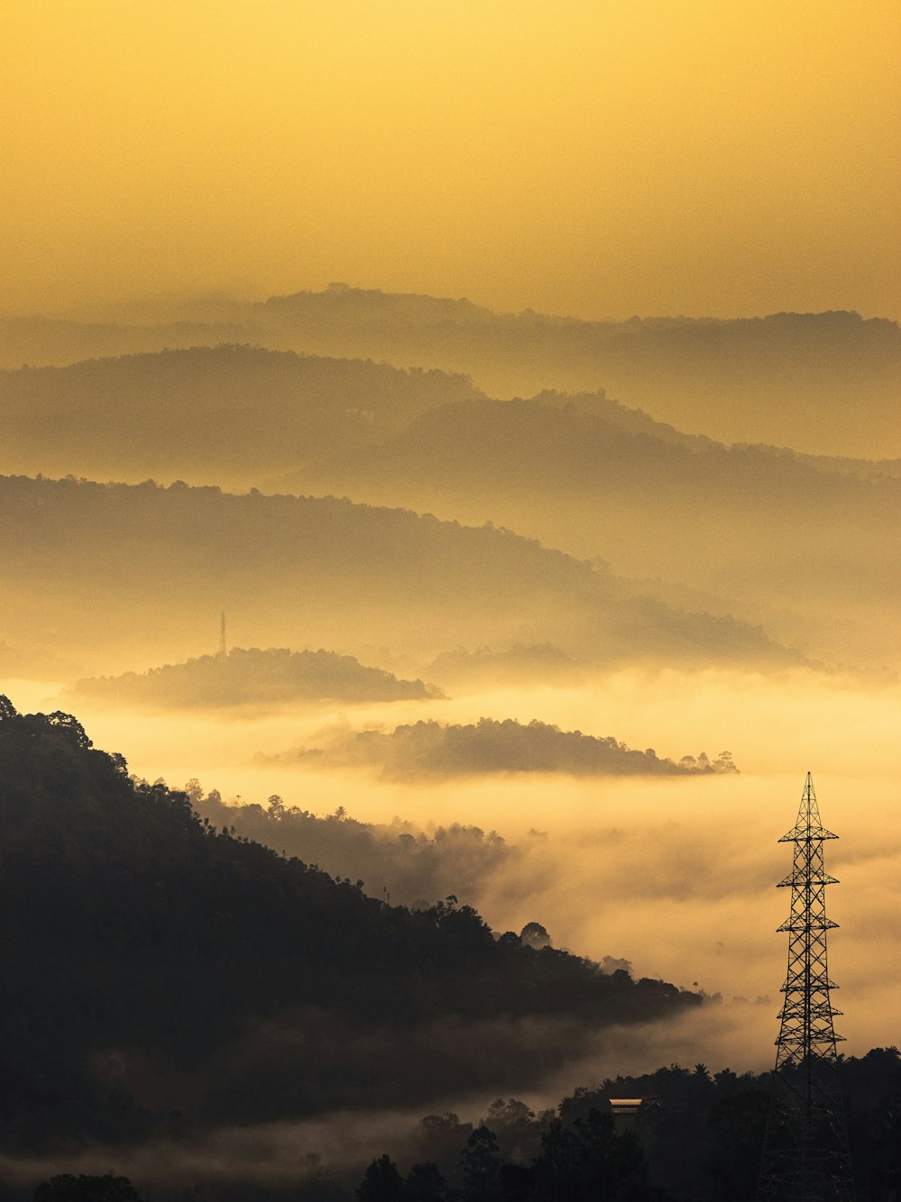 black metal tower under white clouds during daytime