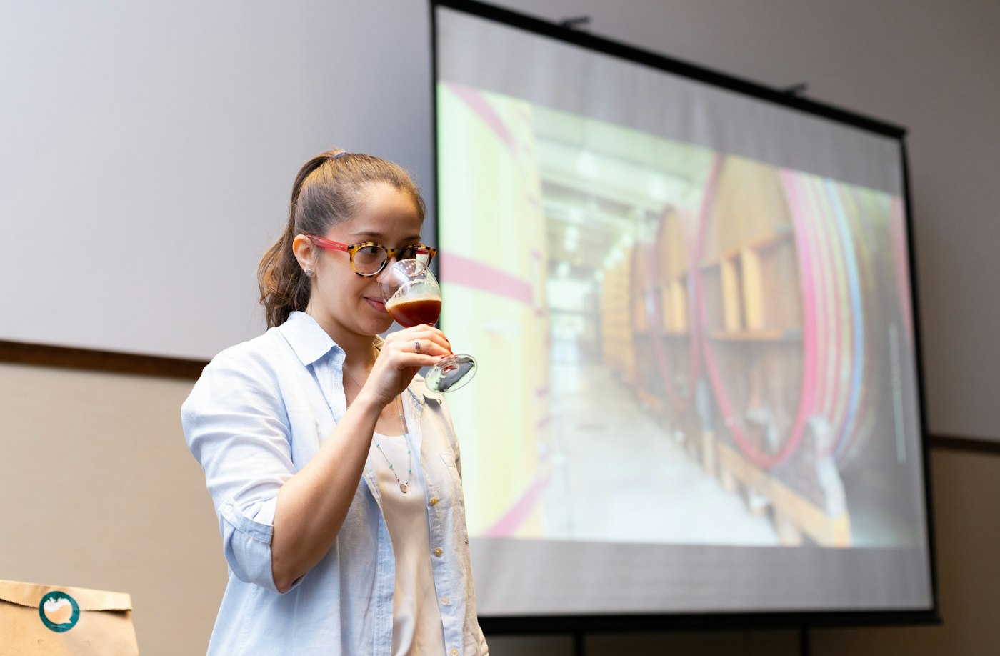 Presenter speaking in front of a projected slide deck