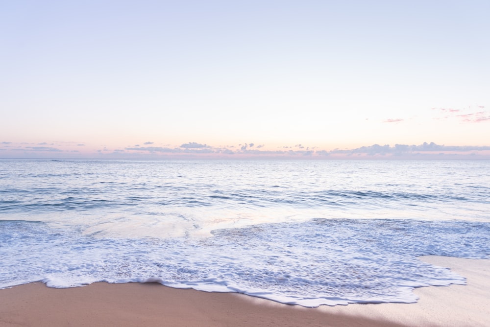 ocean waves crashing on shore during daytime