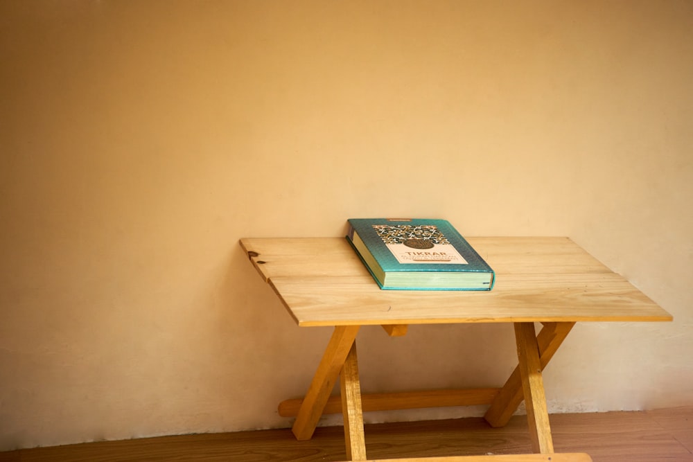 green book on brown wooden table