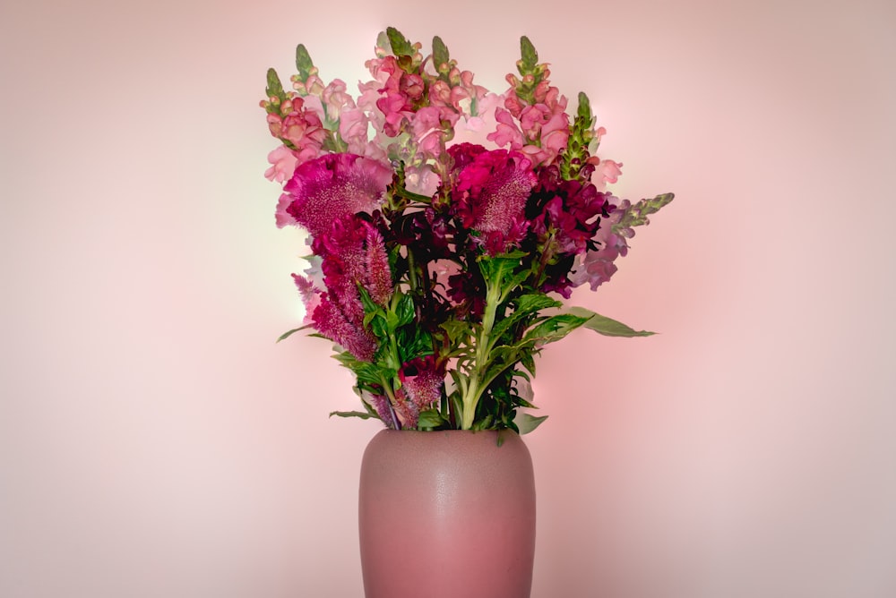 pink flowers in brown ceramic vase