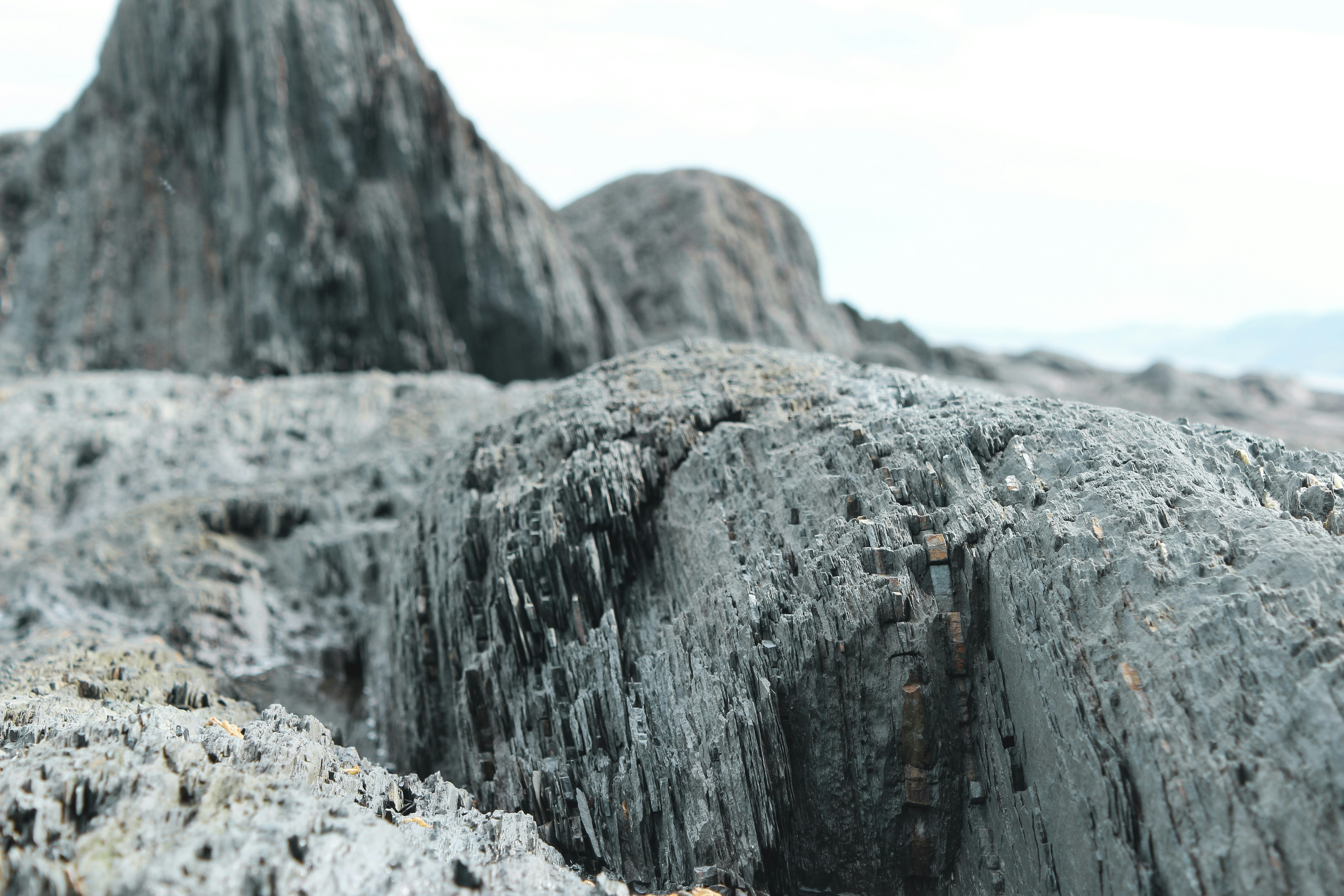 person in black shirt standing on rock formation during daytime