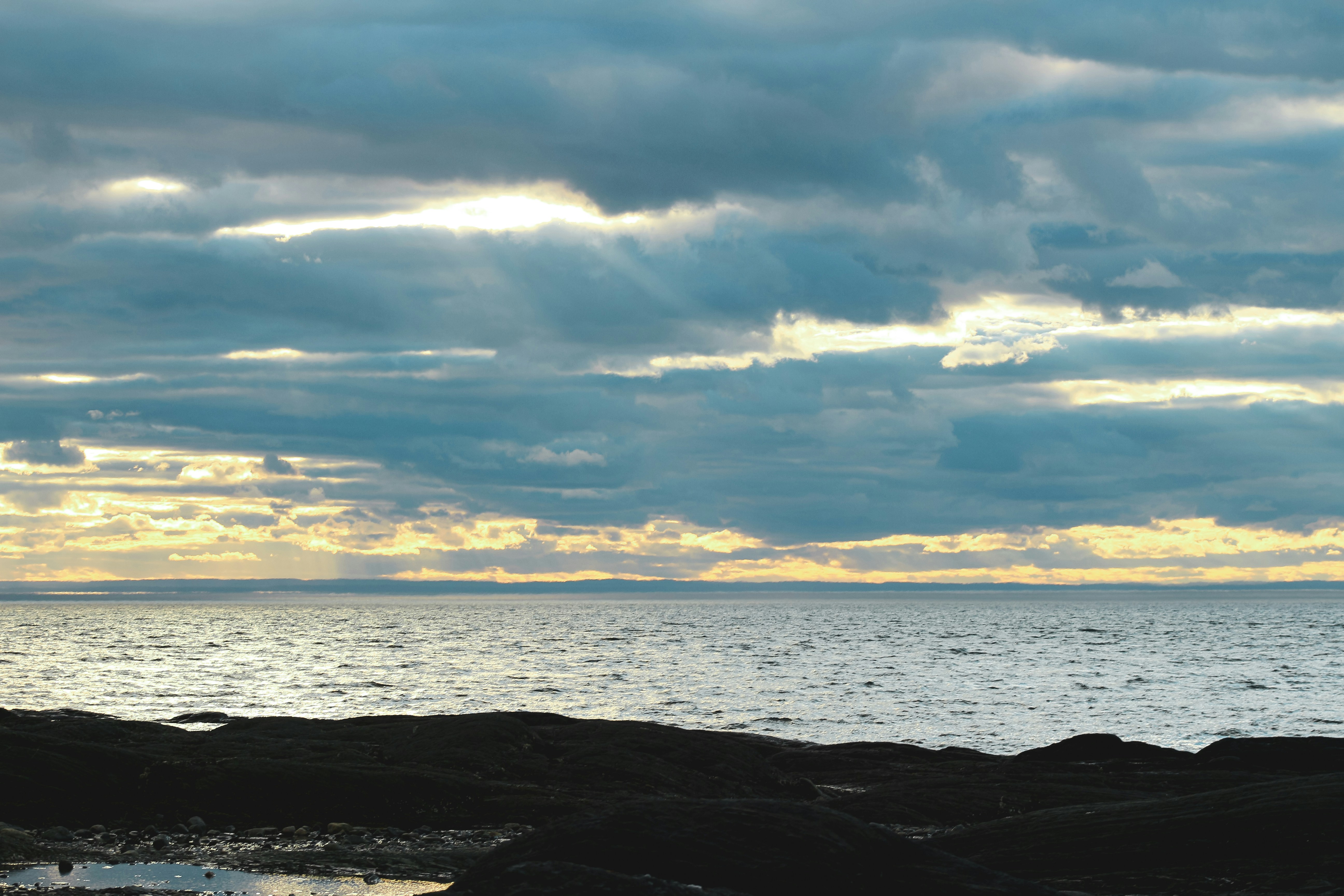 body of water under cloudy sky during daytime