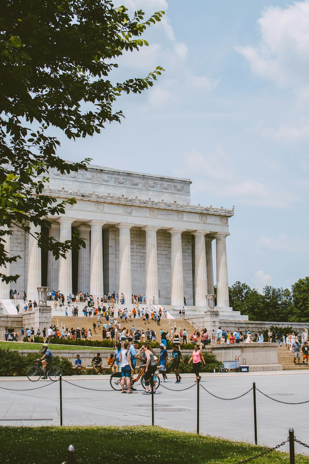 people walking around white concrete building during daytime