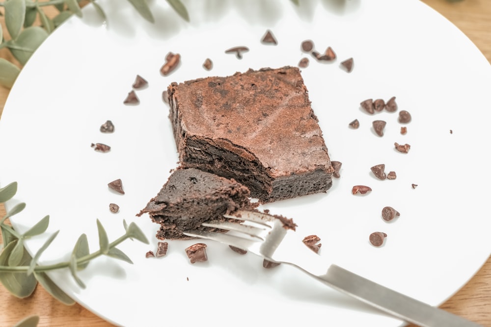 sliced chocolate cake on white ceramic plate