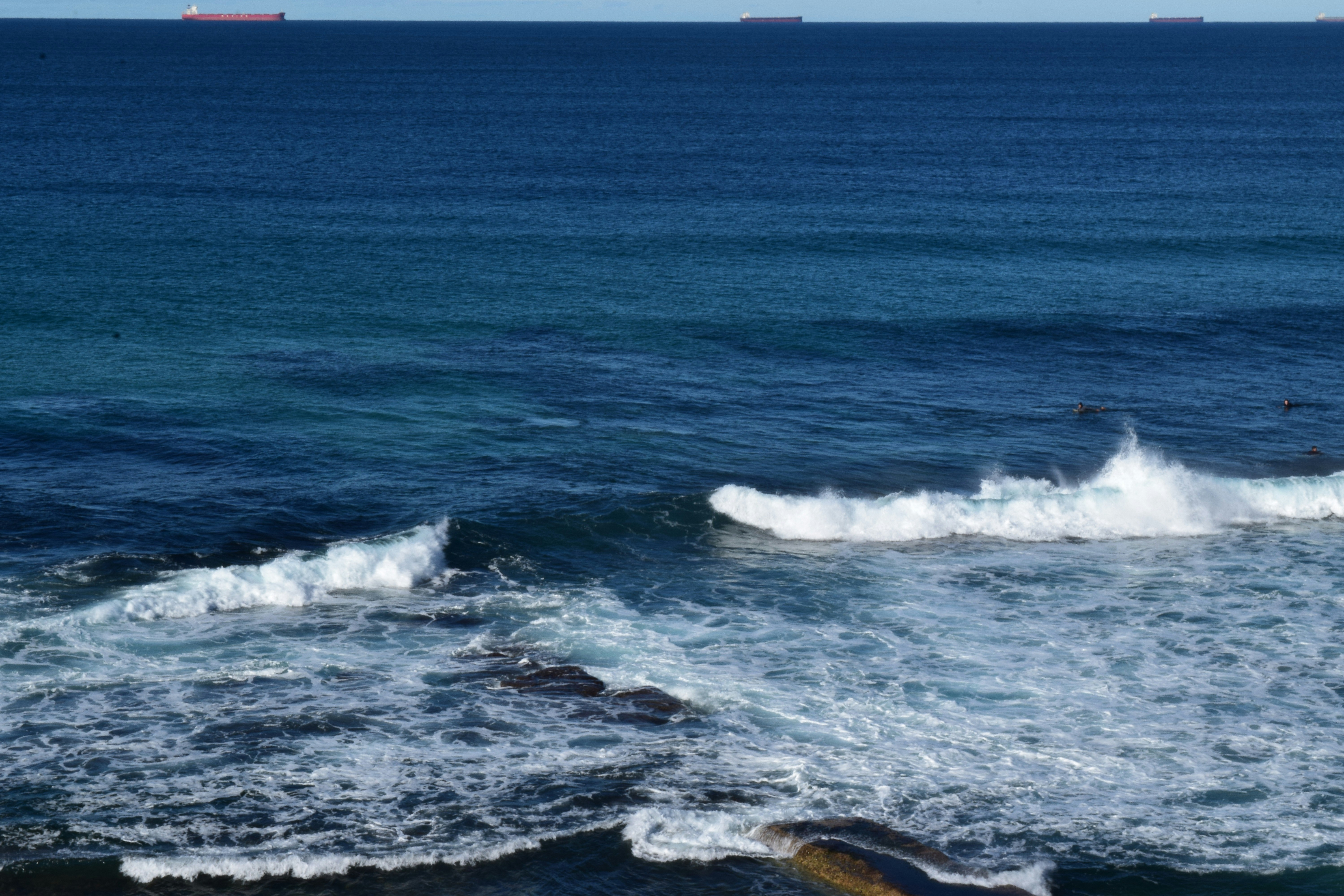 ocean waves crashing on shore during daytime