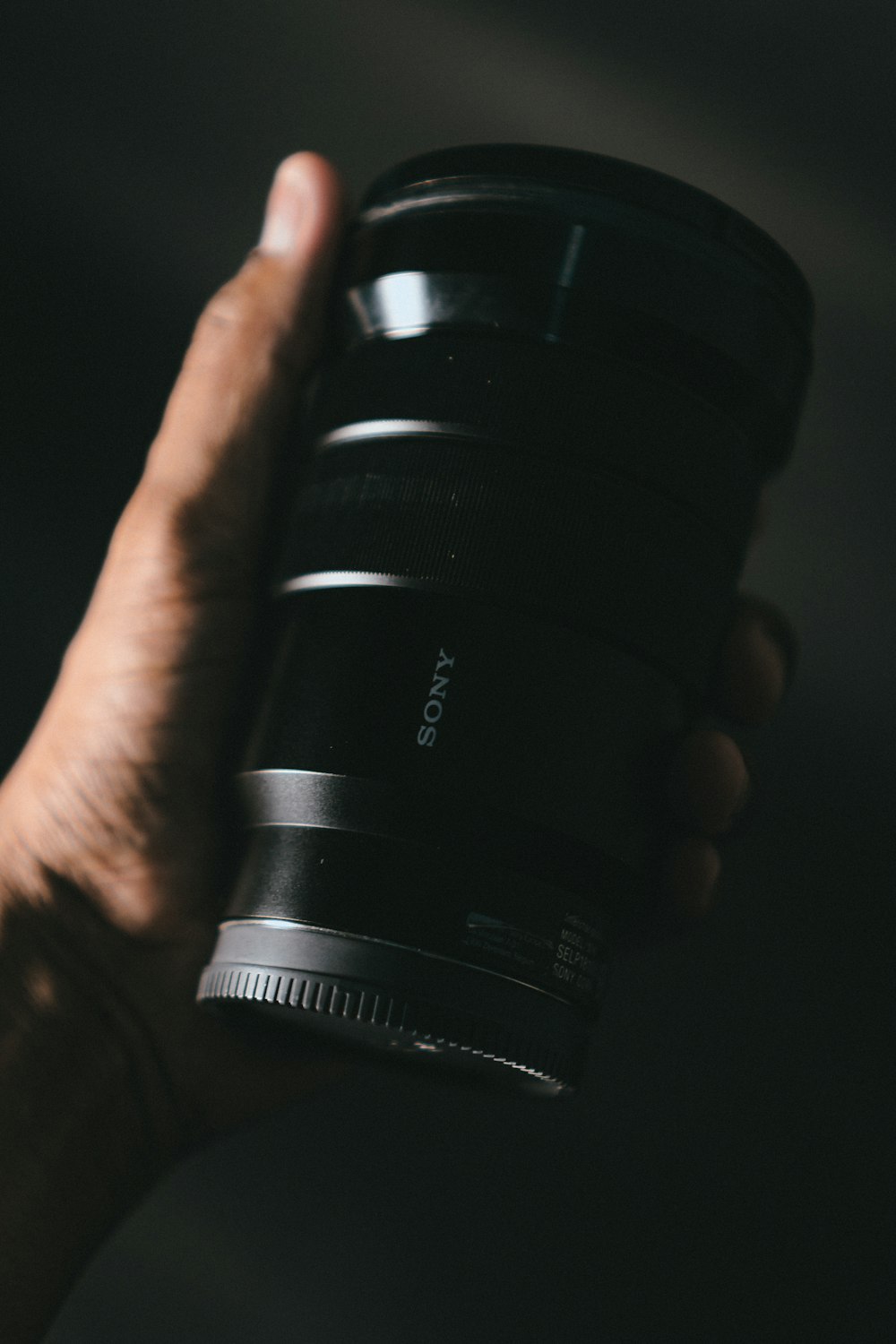 person holding black dslr camera lens