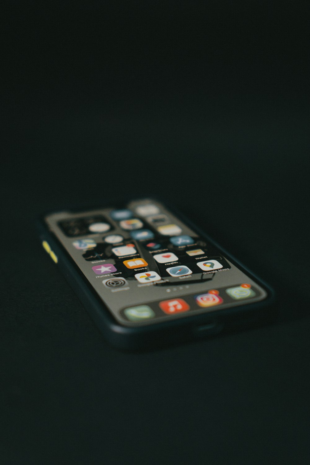 Schwarzes iPhone 4 auf schwarzer Oberfläche